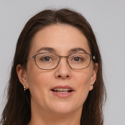 Joyful white adult female with long  brown hair and brown eyes