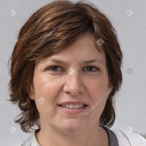 Joyful white adult female with medium  brown hair and blue eyes