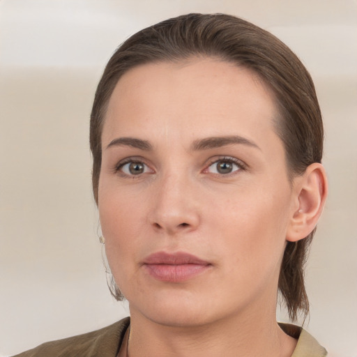 Joyful white young-adult female with short  brown hair and grey eyes