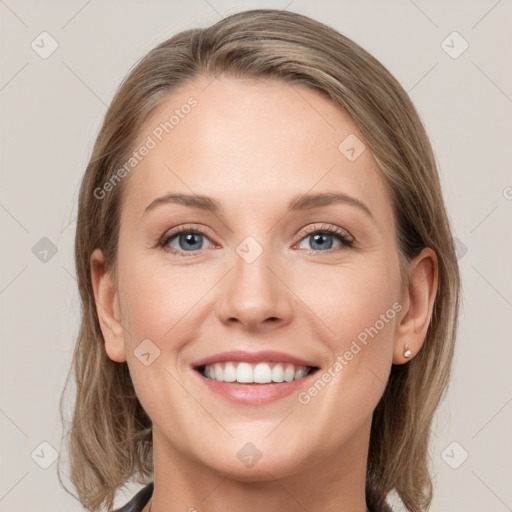 Joyful white young-adult female with medium  brown hair and grey eyes