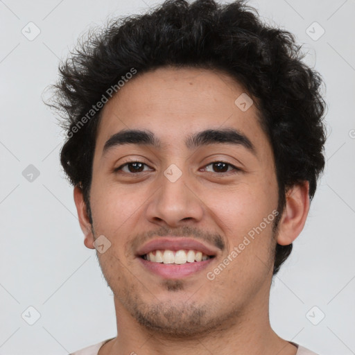 Joyful latino young-adult male with short  brown hair and brown eyes