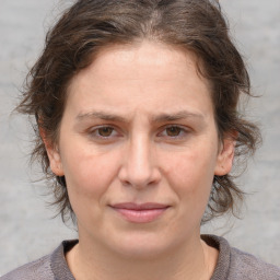 Joyful white adult female with medium  brown hair and grey eyes