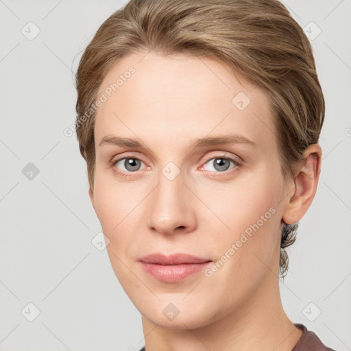 Joyful white young-adult female with short  brown hair and grey eyes