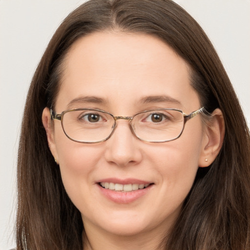 Joyful white adult female with long  brown hair and brown eyes