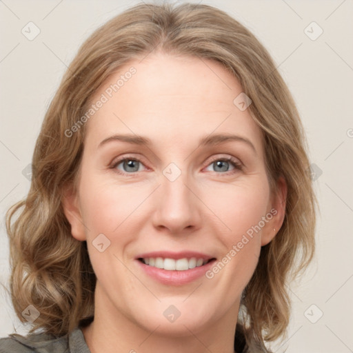 Joyful white young-adult female with medium  brown hair and blue eyes