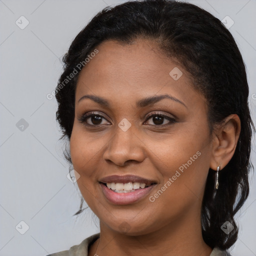 Joyful black young-adult female with long  brown hair and brown eyes