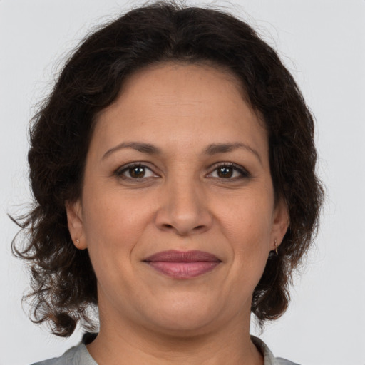 Joyful white adult female with medium  brown hair and brown eyes