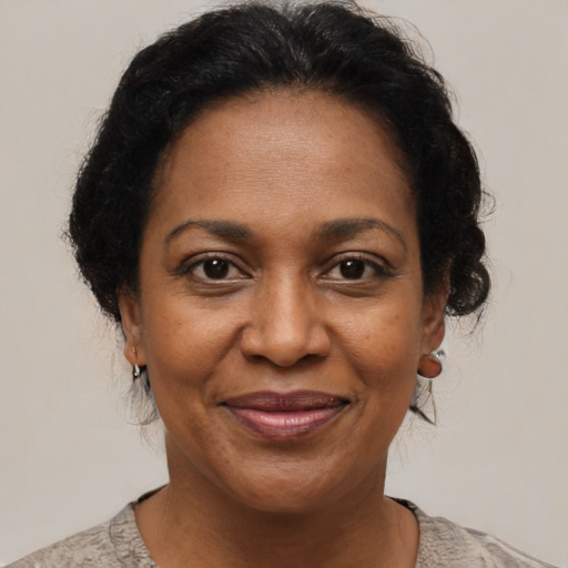 Joyful black adult female with short  brown hair and brown eyes
