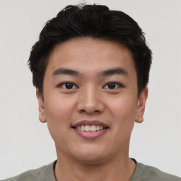 Joyful asian young-adult male with short  black hair and brown eyes