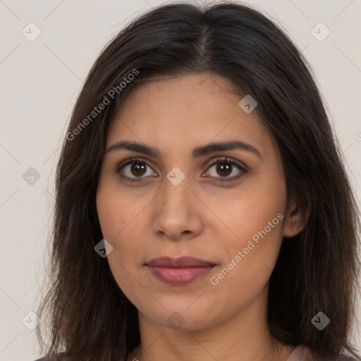 Joyful latino young-adult female with long  brown hair and brown eyes