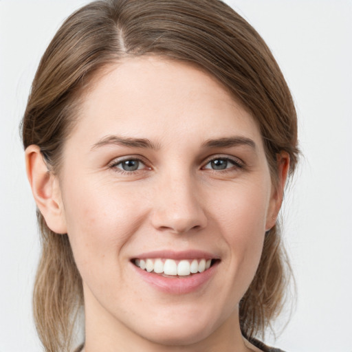 Joyful white young-adult female with long  brown hair and grey eyes