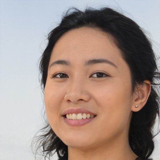Joyful asian young-adult female with long  brown hair and brown eyes