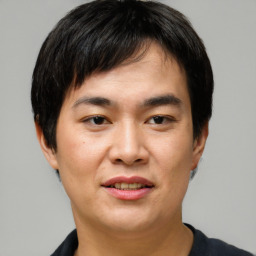 Joyful asian young-adult male with short  black hair and brown eyes