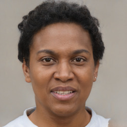 Joyful black adult female with short  brown hair and brown eyes