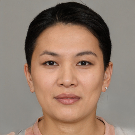 Joyful asian young-adult female with short  brown hair and brown eyes
