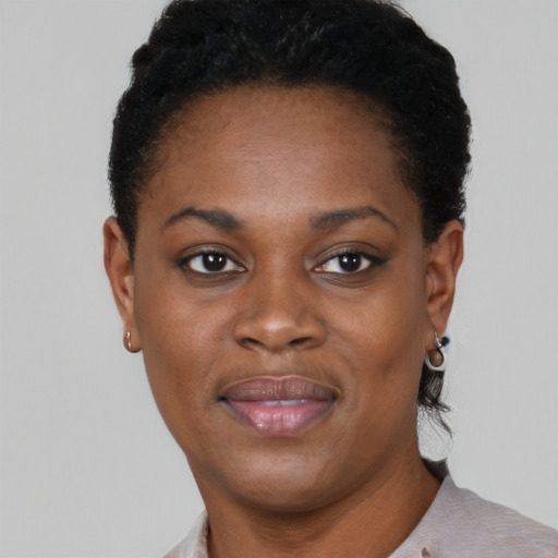 Joyful black young-adult female with short  black hair and brown eyes