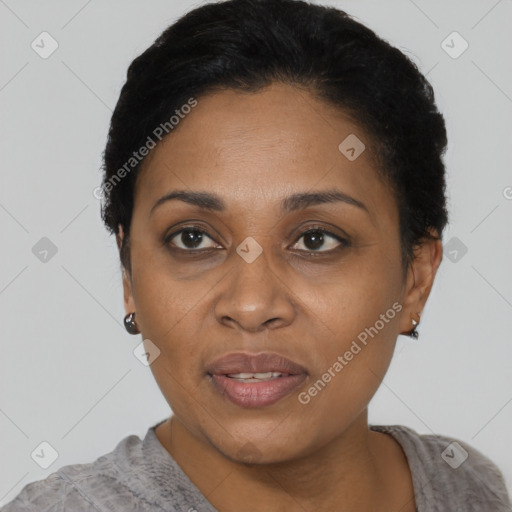 Joyful black adult female with short  black hair and brown eyes