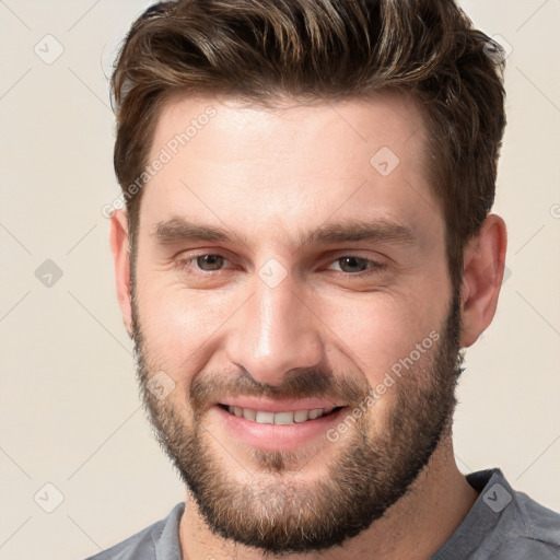 Joyful white young-adult male with short  brown hair and brown eyes