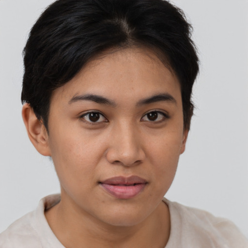 Joyful latino young-adult female with short  brown hair and brown eyes