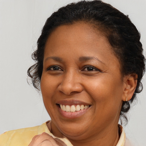 Joyful latino adult female with short  brown hair and brown eyes