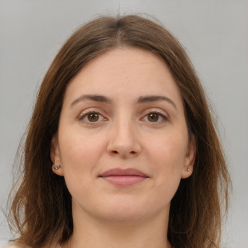 Joyful white young-adult female with long  brown hair and grey eyes