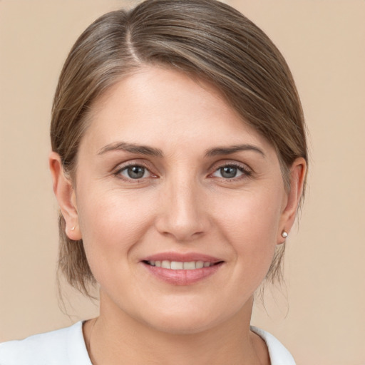 Joyful white young-adult female with medium  brown hair and grey eyes