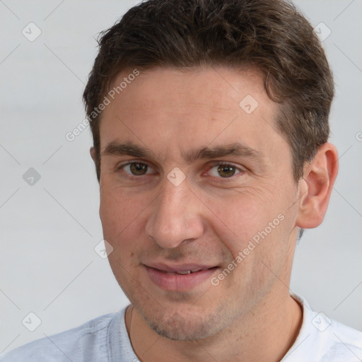 Joyful white adult male with short  brown hair and brown eyes