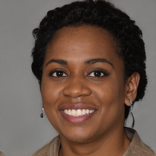 Joyful black young-adult female with short  black hair and brown eyes
