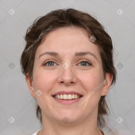 Joyful white young-adult female with medium  brown hair and green eyes