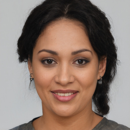 Joyful latino young-adult female with medium  brown hair and brown eyes