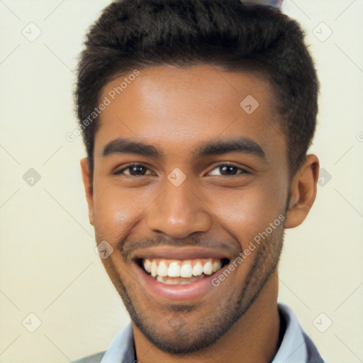 Joyful black young-adult male with short  brown hair and brown eyes