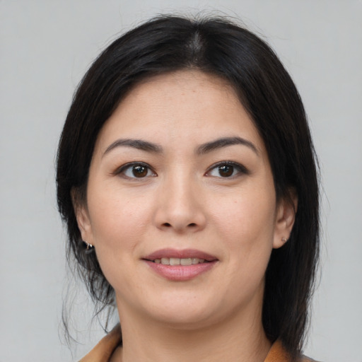 Joyful latino young-adult female with medium  brown hair and brown eyes