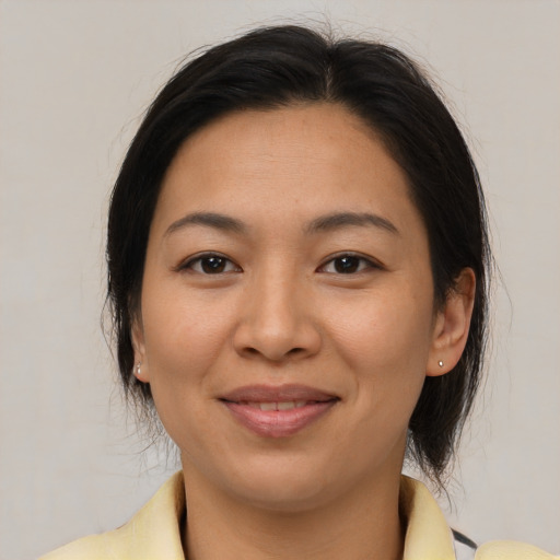 Joyful asian young-adult female with medium  brown hair and brown eyes
