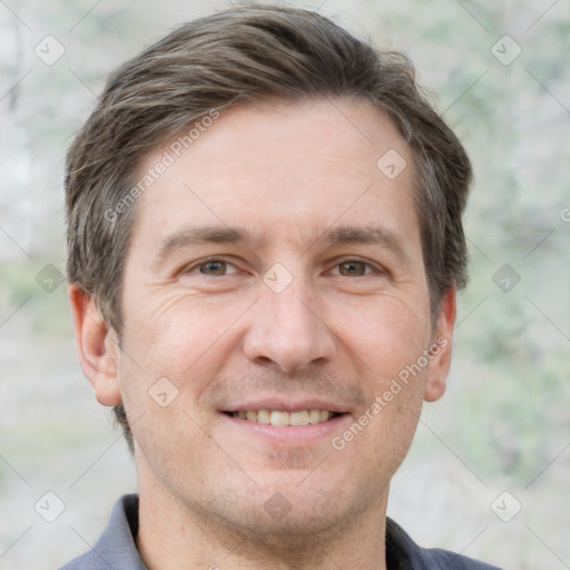 Joyful white adult male with short  brown hair and grey eyes