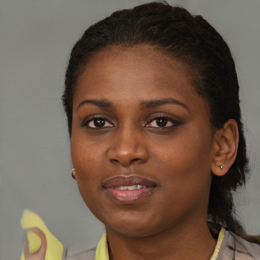 Joyful black young-adult female with short  brown hair and brown eyes