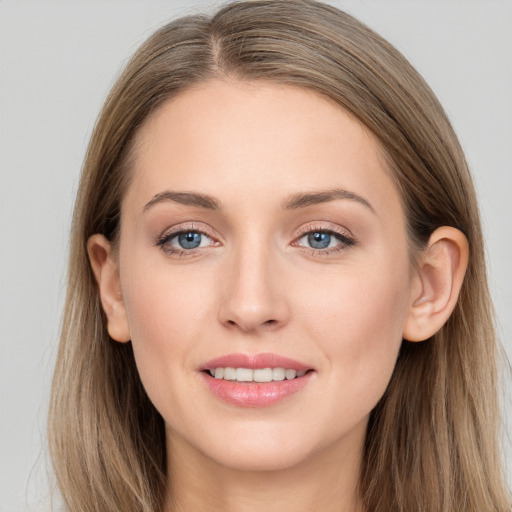 Joyful white young-adult female with long  brown hair and grey eyes