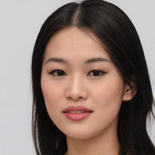 Joyful asian young-adult female with long  black hair and brown eyes