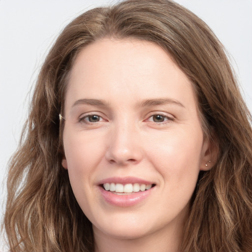 Joyful white young-adult female with long  brown hair and grey eyes