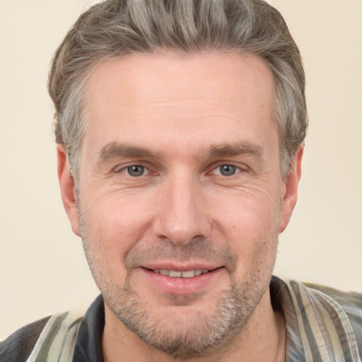 Joyful white adult male with short  brown hair and grey eyes