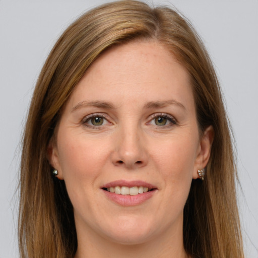 Joyful white adult female with long  brown hair and green eyes