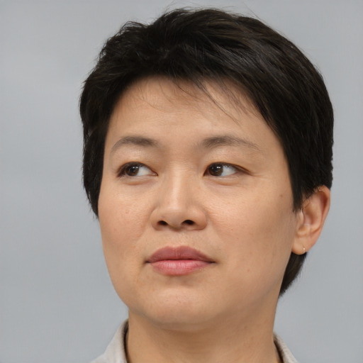 Joyful asian adult female with short  brown hair and brown eyes