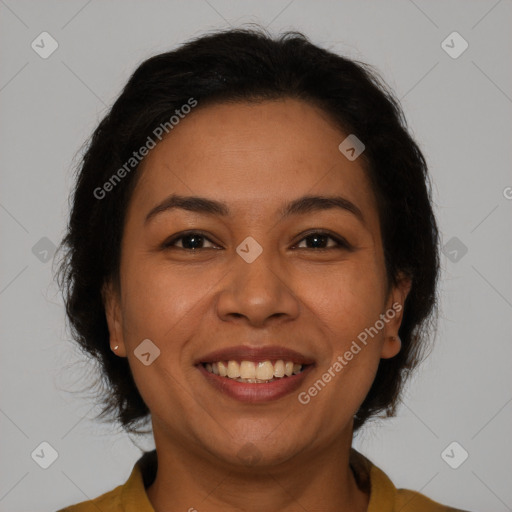 Joyful latino adult female with medium  brown hair and brown eyes