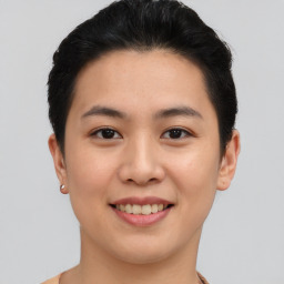 Joyful asian young-adult female with short  brown hair and brown eyes