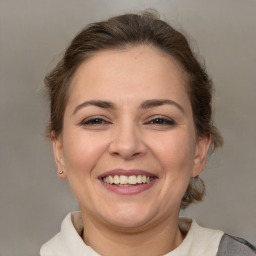 Joyful white adult female with medium  brown hair and brown eyes