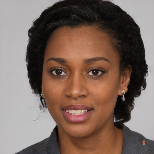 Joyful black young-adult female with medium  black hair and brown eyes