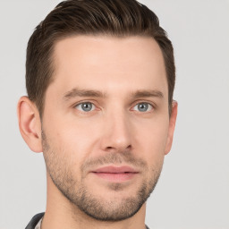 Joyful white young-adult male with short  brown hair and grey eyes