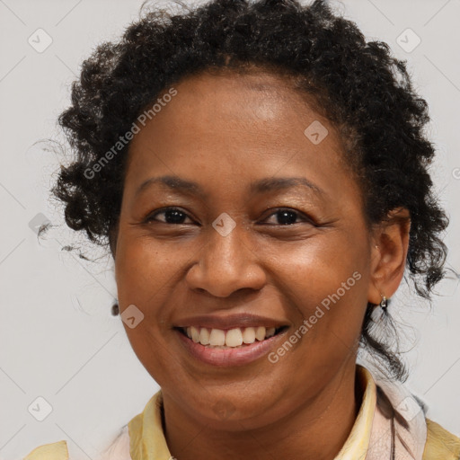 Joyful black adult female with short  brown hair and brown eyes