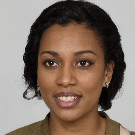 Joyful black young-adult female with medium  black hair and brown eyes