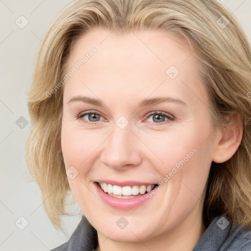 Joyful white young-adult female with medium  brown hair and blue eyes