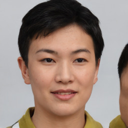 Joyful asian young-adult female with short  brown hair and brown eyes